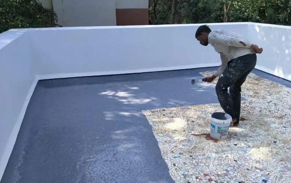 Roof waterproofing being applied